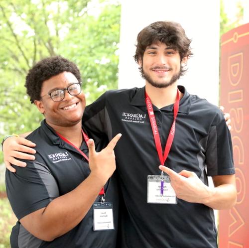 Two college students smile at the camera